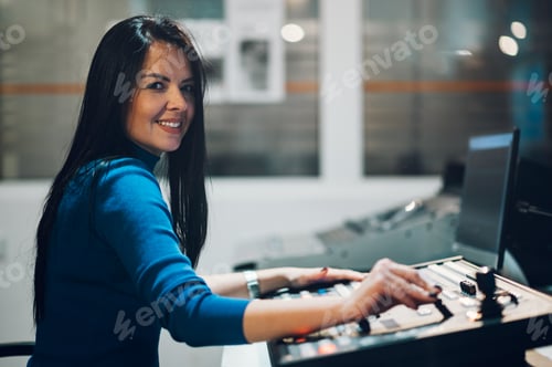 Preview: Middle aged woman using equipment in control room on a tv station