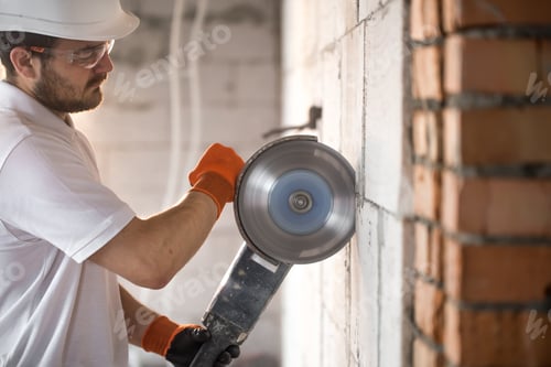 Preview: The industrial Builder works with a professional angle grinder to cut bricks.
