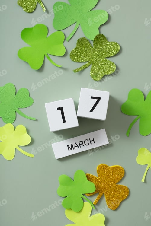 Preview: March 17 calendar and green clover leaves top view. St. Patrick's Day concept