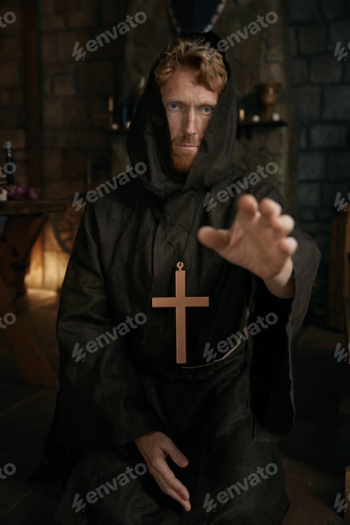Preview: Portrait of friar wearing robe and golden cross reaching hand to camera