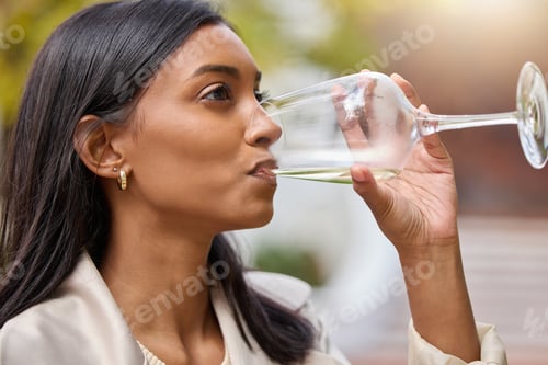 Preview: Shot of an attractive young woman sitting alone and drinking a glass of wine