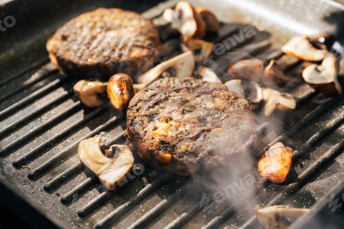 Preview: Burger Patties and Mushrooms Cooking on Grill