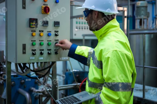 Preview: Engineer specialist using laptop checking and maintaining machine in factory