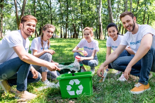 Preview: young volunteers with green recycling box cleaning park