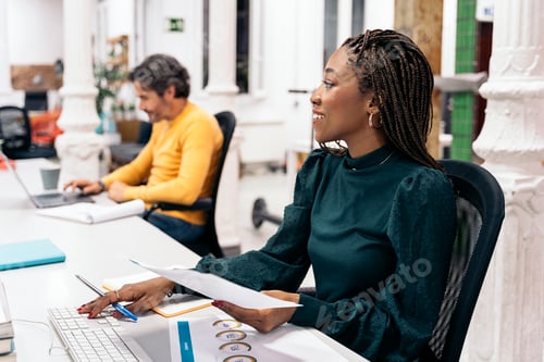Preview: Happy African Woman Working in the Office