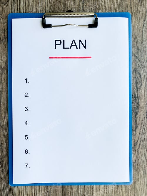 Preview: Clipboard with text plan on wood desk.