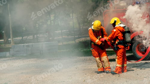 Preview: Firefighter fighting with flame using fire hose chemical water foam spray engine. Fireman hard hat