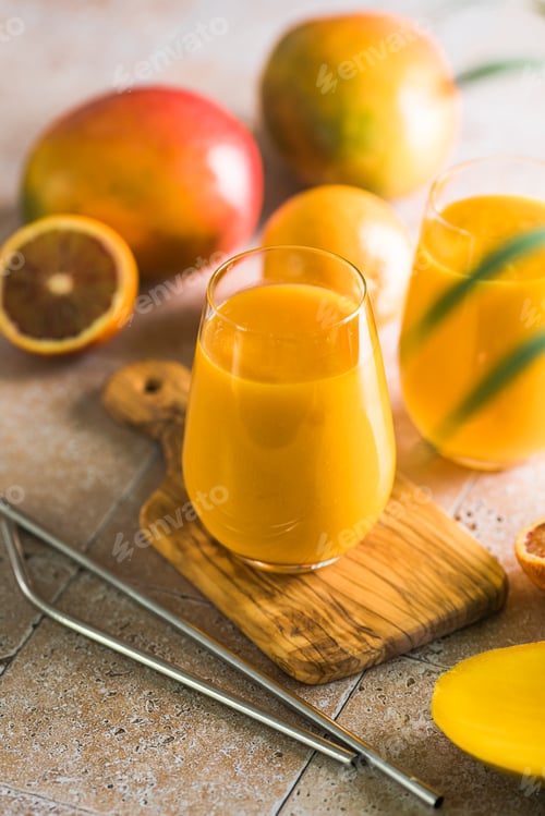 Preview: Two mango lassi or kesar milk in glasses. Indian healthy ayurvedic cold drink with mango.