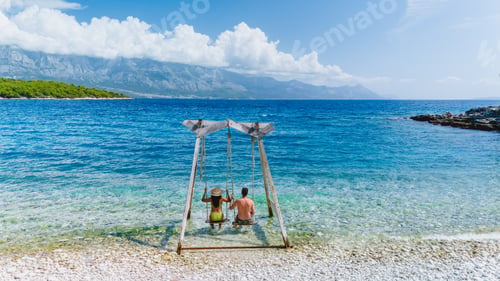 Preview: Relaxing moments on the swing by the stunning Brac Island shore in Croatia under a sunny sky