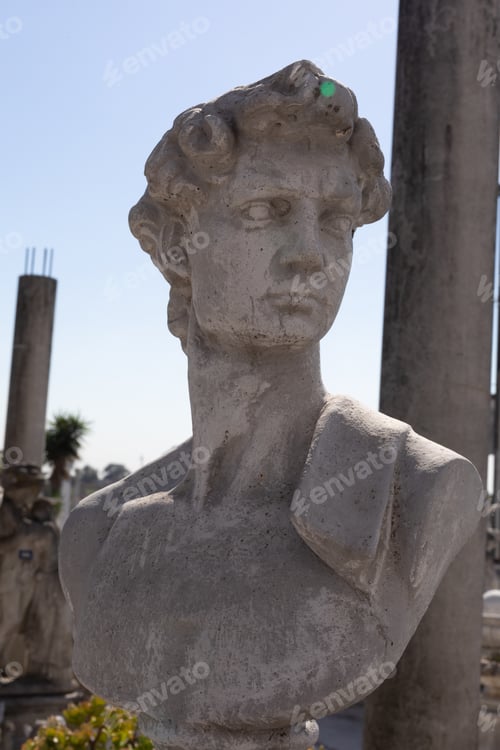 Preview: Ancient stone sculpture of man's bust in reclamation yard