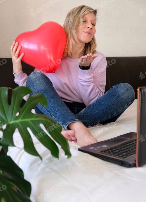 Preview: Woman with Balloon Sending Air Kiss at Home