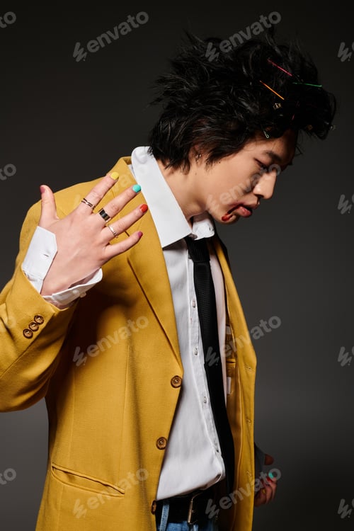 Preview: Stylish asian man showcases spring fashion with vibrant colors in studio atmosphere
