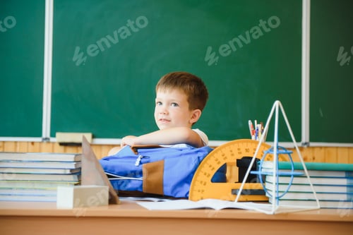 Preview: Education and learning. Little schoolboy in classroom. Schoolboy doing homework in classroom