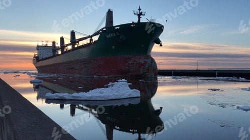 Preview: A freight ship coming into port during sunrise