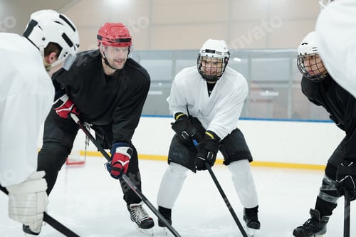 Preview: Group of professional young hockey players and their trainer in sports uniform