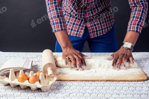 Preview: African American male cook chef boasts pastry hands in flour baking .