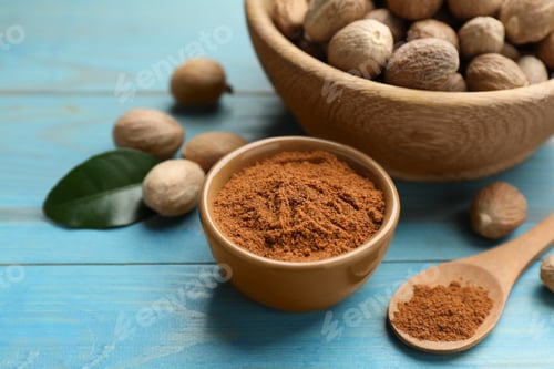 Preview: Nutmeg powder and seeds on light blue wooden table