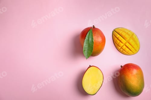 Preview: Flat lay composition with ripe mangoes and space for text on color background