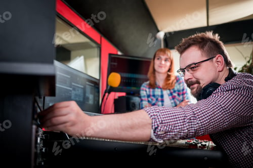 Preview: Music producer and musician in recording studio using soundboard for mixing sound