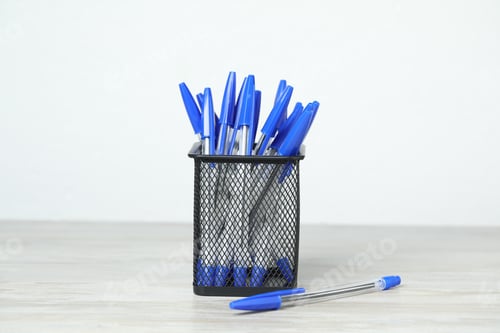 Preview: Many ballpoint pens in holder on wooden table