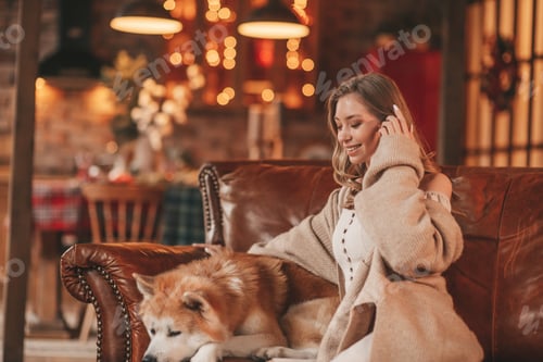 Preview: Candid authentic happy married couple spends time together with japanese dog at Xmas lodge