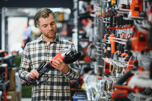 Preview: A man chooses a power tool in a hardware store