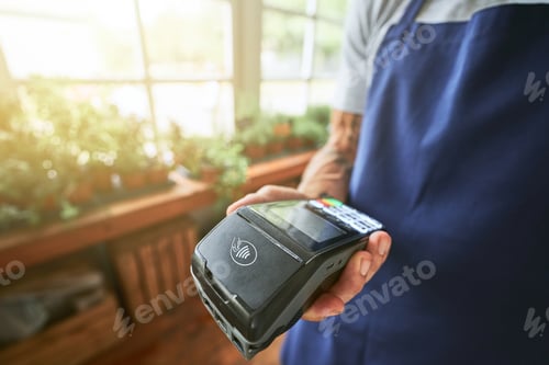 Preview: Bank terminal in male seller hand