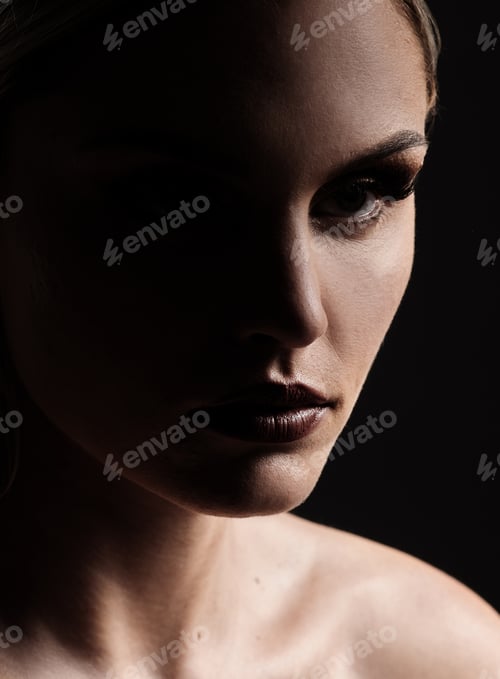 Preview: Studio shot of a woman woman posing against a black background