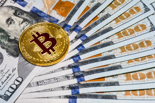 Preview: Symbolic coins of bitcoin on banknotes of one hundred dollars