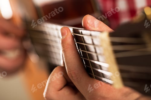 Preview: Music, close-up. Musician holding a wooden guitar