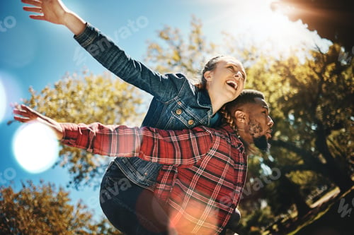 Preview: Young couple, flying and piggyback in park, summer and date together in sunshine, happiness or natu