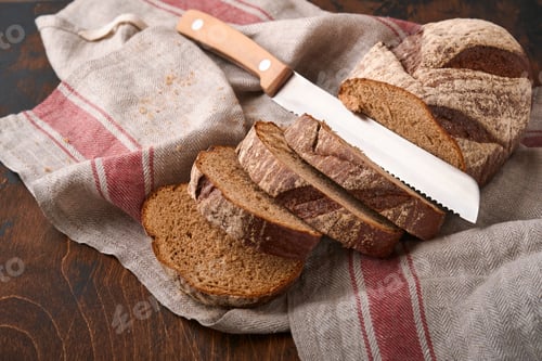 Preview: Fresh homemade rye bread. Traditional spelled sourdough bread cut into slices on a rustic wooden bac