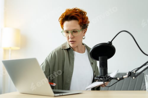 Preview: Content creator recording podcast using laptop and microphone