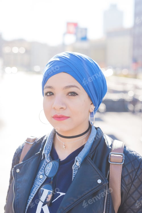Preview: Portrait arabian young woman wearing hijab outdoor looking camera