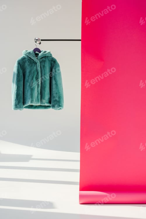 Preview: fluffy green faux fur coat on hanger with pink wallpaper