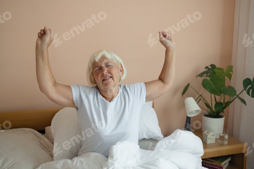 Preview: Portrait of beauty Caucasian 50s 60s woman awaking, wake up on the bed. Young beautiful female