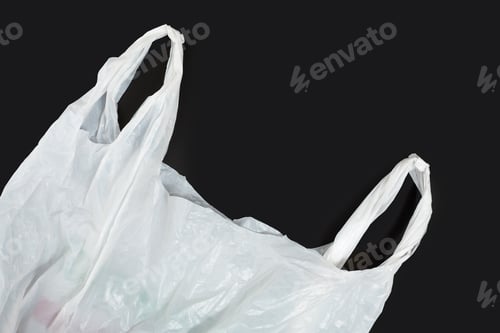 Preview: White Plastic Bag On Black Background. A White Plastic Bag Texture, Macro, Background. Reduction Of