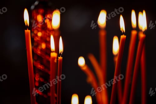 Preview: last candle burn in an Orthodox church. Church candle burn on a large gold candlestick in the churc