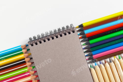Preview: colored pencils and notepad on the table