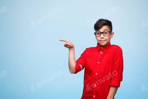 Preview: Young boy pointing on side
