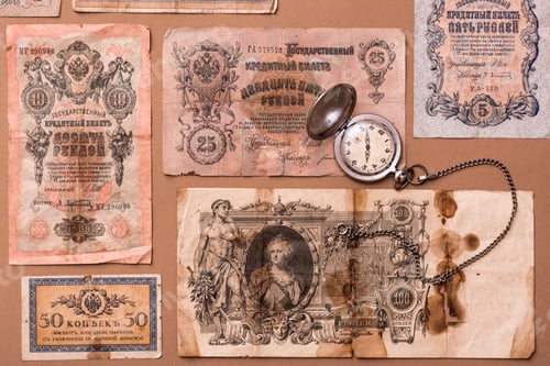 Preview: Old worn out of circulation ruble banknotes of tsarist russia and a watch on a chain