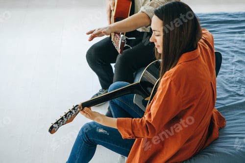Preview: Woman Plays Acoustic Guitar with Friend