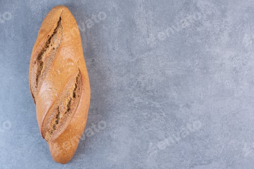 Preview: Single loaf of baton bread on marble background