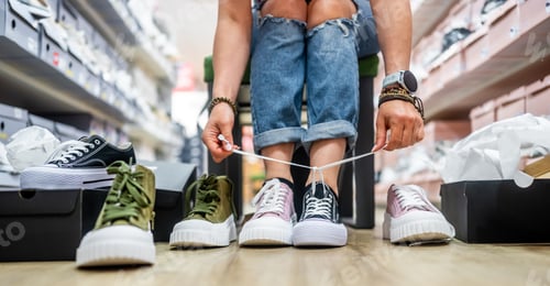 Preview: Woman Trying On Sneakers In Different Colors