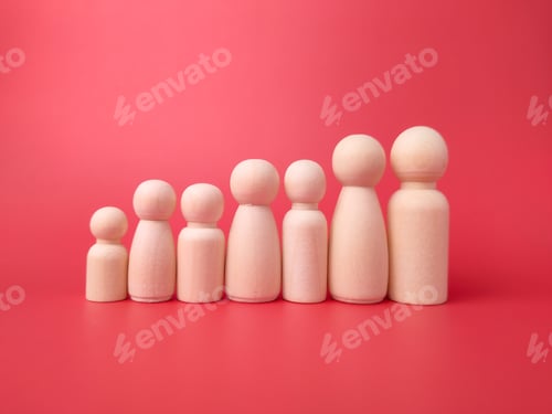 Preview: Wooden figures on a red background. Concept of family.