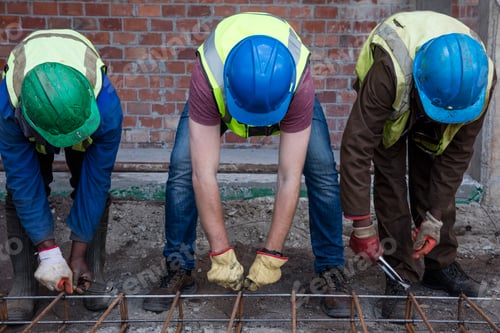 Preview: Construction workers on a construction site assembling reinforcing steel