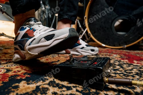 Preview: man's foot pressing bass drum pedal in recording studio drummer drumming indoors closeup