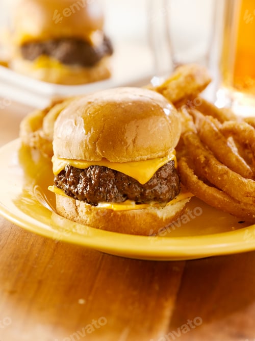 Preview: mini burgers with cheese and onion rings served with beer.
