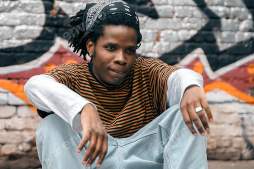 Preview: Portrait of young handsome stylish black man with skateboard. African american skateboarder man. Nat
