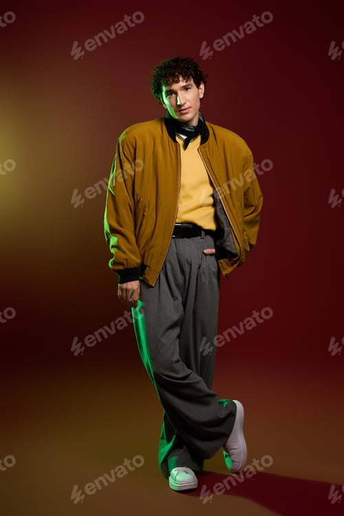 Preview: Handsome man showcases stylish attire against a vibrant backdrop for a fashion forward look